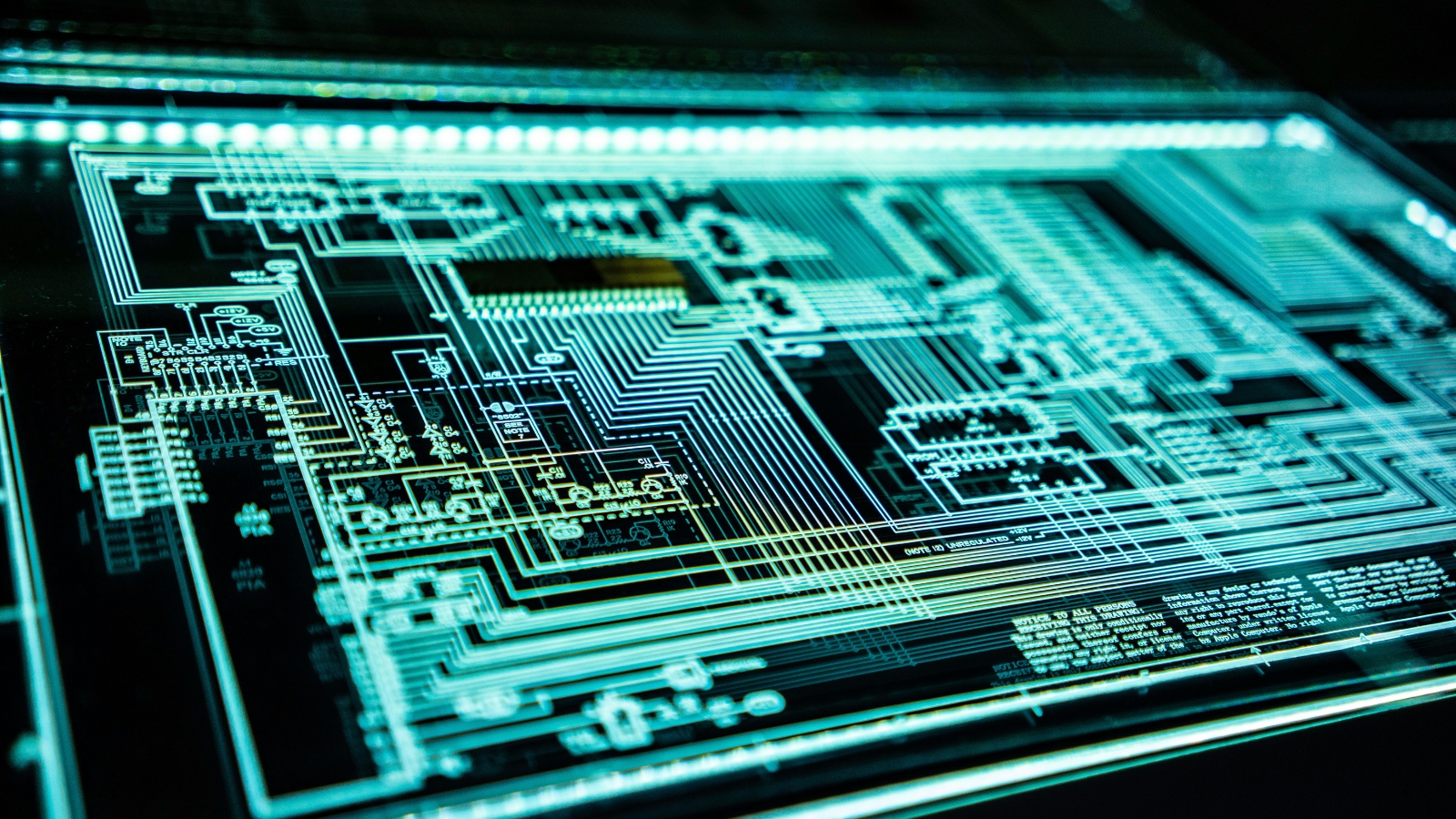 A teal LED server panel, representing the network activity that AI monitors and responds to across the security lifecycle.